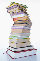 stack of colored books on white table