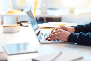 Man using laptop, close up of hands