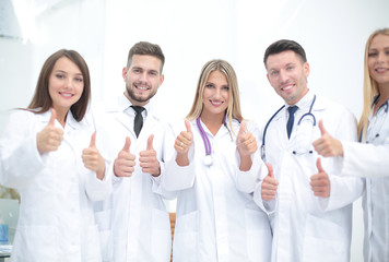 Fototapeta premium Portrait of a doctor and medical team showing thumb up