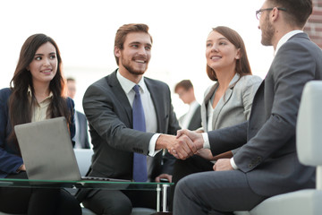 Two colleagues handshaking after meeting.