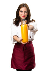 Beautiful chef woman holding a orange juice