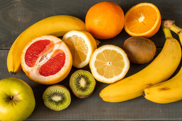 Composition from fresh fruits on a wooden background