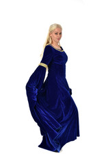 Naklejka premium full length portrait of pretty blonde lady wearing a blue fantasy medieval gown. standing pose on white background.