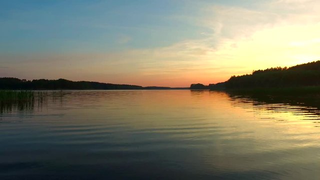 Calm sunset over the lake in the summer