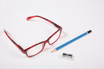 glasses, pencil and sharpener isolated on white background