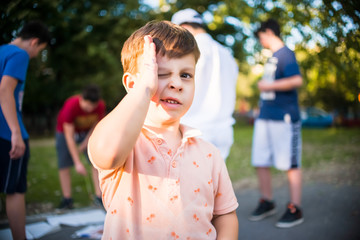 Obraz premium Portrait of smiling little boy into the park