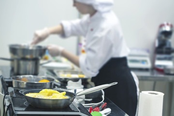 Potatoes are fried in a frying pan. Selective focus.