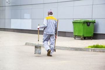 Road sweeper worker cleaning city street Horizontal