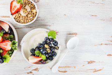 Bowl of natural yogurt with granola and fresh berries