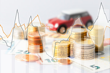 Euro coins in pile on Euro banknotes with charts und car, for background. Germany