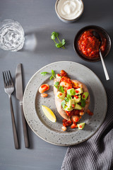 baked sweet potatoes with avocado chili salsa and beans
