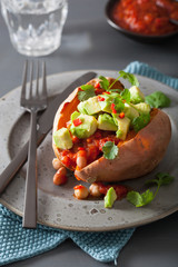 baked sweet potatoes with avocado chili salsa and beans