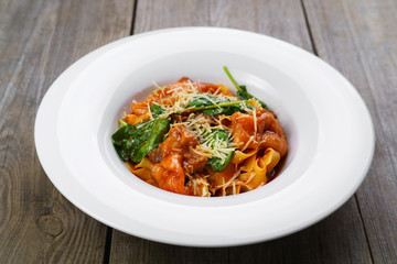 Traditional food, national Italian cuisine, delicious pasta with salmon and spinach. Nourishing and tasty meals. Restaurant, banquet, dinner concept