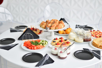 Beautiful breakfast. A lot of food. European breakfast. White table. 