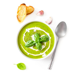 Spinach soup with cream in a bowl. Broccoli and Spinach creamy soup with  croutons isolated on white background, top view. Close up. Detox healthy  food.