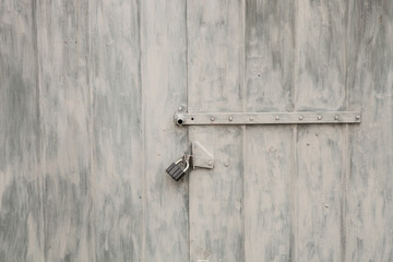 Old rusty padlock on the metal door