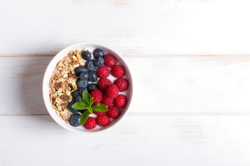 Smoothie bowl with yogurt, fresh berries and cereal