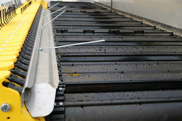 The image of a black, rubber conveyor belt.