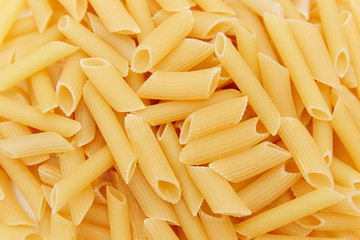 heap of raw pasta. top view. background. close up. italian food or cuisine