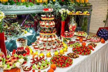 Fototapeta na wymiar Delicious sweets on candy buffet. Lot of colorful desserts
