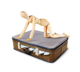 Rich man is sitting on all fours on a suitcase full of money. Concept of greed