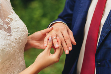 marriage hands with rings. birde wears the ring on the finger of the groom