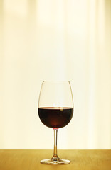 Single Red Wine in Bordeaux-shaped glass on the center of Copper Counter Top, with defocused Window and White Curtain, plain background, No decoration, Ambient Warm Day Lighting Studio image 2