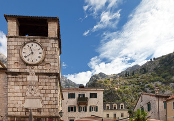 Fototapeta na wymiar Montenegro. Old Town Kotor. The Clock Tower on the Square of Arms is famous tourist landmark and UNESCO World Heritage site. Medieval Church of Our Lady of Remedy on mountain