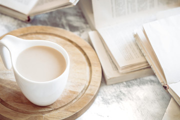 a cup of coffee with books