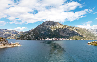 Fototapeta na wymiar Montenegro. Boka Kotor Bay. View from the water on the coastlines and the beautiful Perast town