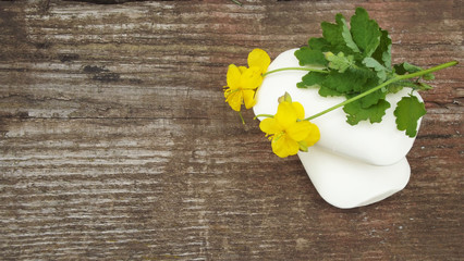Cosmetic soap with celandine extract and towel.