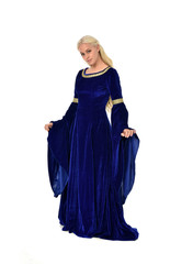Naklejka premium full length portrait of pretty blonde lady wearing a blue fantasy medieval gown. standing pose on white background.