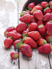 Red ripe big strawberry group on a white old vintage background