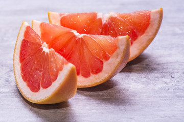Grapefruit slices, juicy ripe isolated on a gray background