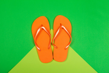 Beach flip flop on color background