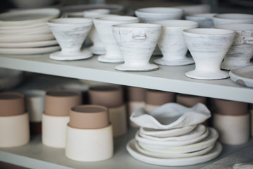 Handcrafted on a potter's wheel,Hands make clay from various items for home and sale in the store and at the exhibition, ceramic items are made in hand, the clay billet becomes a ceramic dish