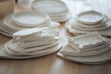 Handcrafted on a potter's wheel,Hands make clay from various items for home and sale in the store and at the exhibition, ceramic items are made in hand, the clay billet becomes a ceramic dish