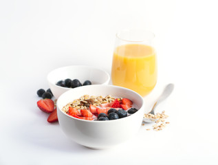 Smoothie bowl with yogurt, fresh berries and cereal. Isolated on white background