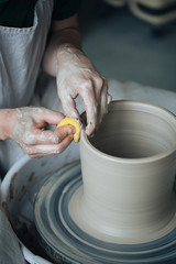 Handcrafted on a potter's wheel,Hands make clay from various items for home and sale in the store and at the exhibition, ceramic items are made in hand, the clay billet becomes a ceramic dish