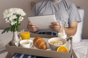 Man reading news on tablet computer