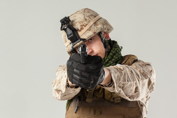 Soldier in camouflage holding rifle
