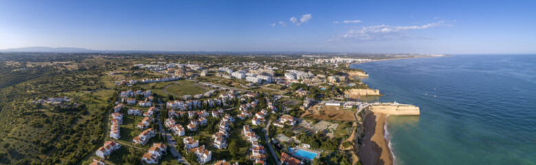 Aerial rocky famous seascape cape and Senhora da Rocha church on top of the cliff, in Algarve.