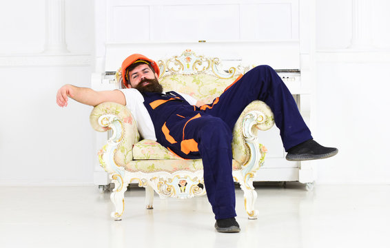 Bearded Worker Lying In Vintage Armchair Isolated On White Background. Tired Mover Enjoying Short Break