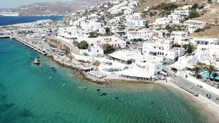 Aerial drone, bird's eye view photo of iconic and traditional whitewashed old port of Mykonos...