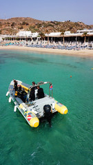 Aerial drone photo of divers in diving school inflatable in famous clear turquoise water beach of...