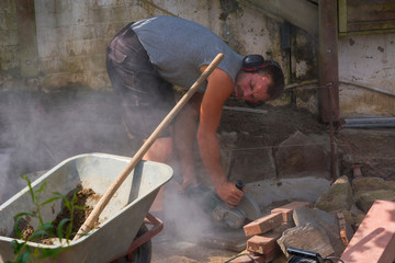 Workers with cut-off grinder in use