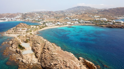 Obraz premium Aerial drone bird's eye view of famous Paraga beach featuring iconic beach bar of Skorpios and Santa Anna, Mykonos island, Cyclades, Greece