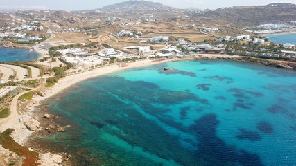 Fototapeta na wymiar Aerial drone bird's eye view of famous Paraga beach featuring iconic beach bar of Skorpios and Santa Anna, Mykonos island, Cyclades, Greece