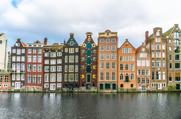 A row of old traditional houses at the Damrak in Amsterdam