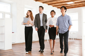 Group of smiling young multiethnic businesspeople